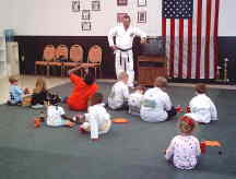 Children listen to sensei Hobbs explaining self defense