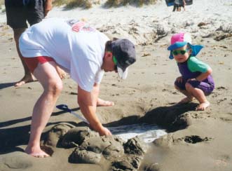 Fun with Dad at the beach.
James wears his sunsafe gear.