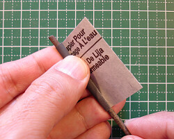 Sanding with a rolled piece of sandpaper.