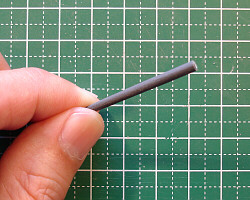 Sanding with a rolled piece of sandpaper.