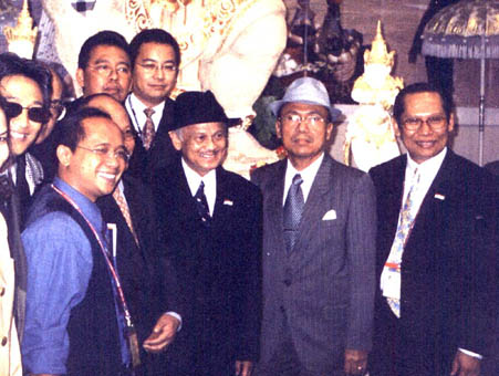 seen in the picture standing just behind the former President during his visit