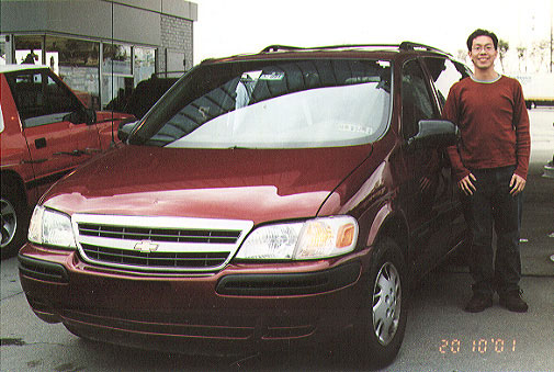 Colin's red matches the car's maroon red