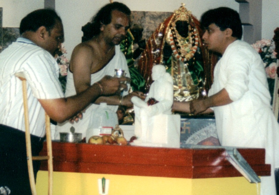 Abhishek being performed to Saibaba's Murti by participating devotees