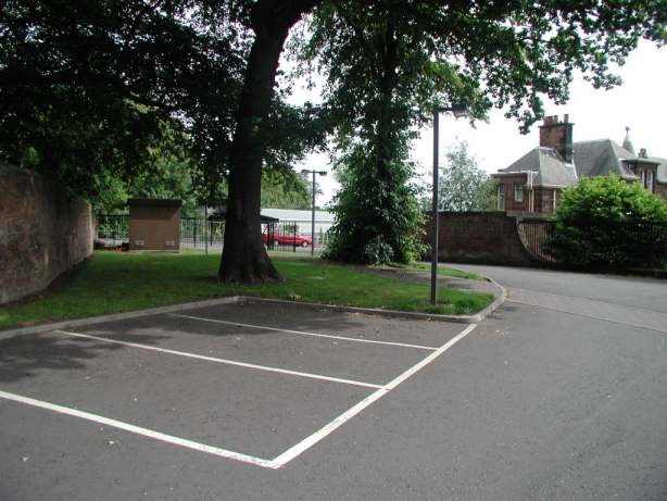 Vehicle entrance and driveway, with Gatehouse beyond