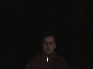 Peter stands in the rain at the graveyard