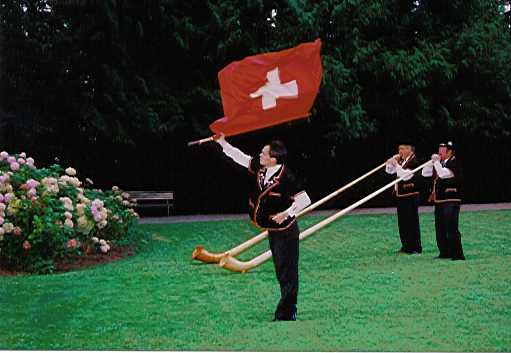 Traditional Swiss Alphorn blowing and flag waving