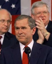 George W. Bush. (The fat ugly guy behind him is Speaker Hastert)