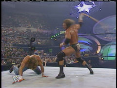 HHH uses Shawn's belt as a weapon