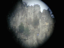 Climbers scaling Seneca Rocks through a telescope lens