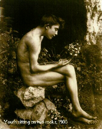 Youth sitting on two rocks, 1900