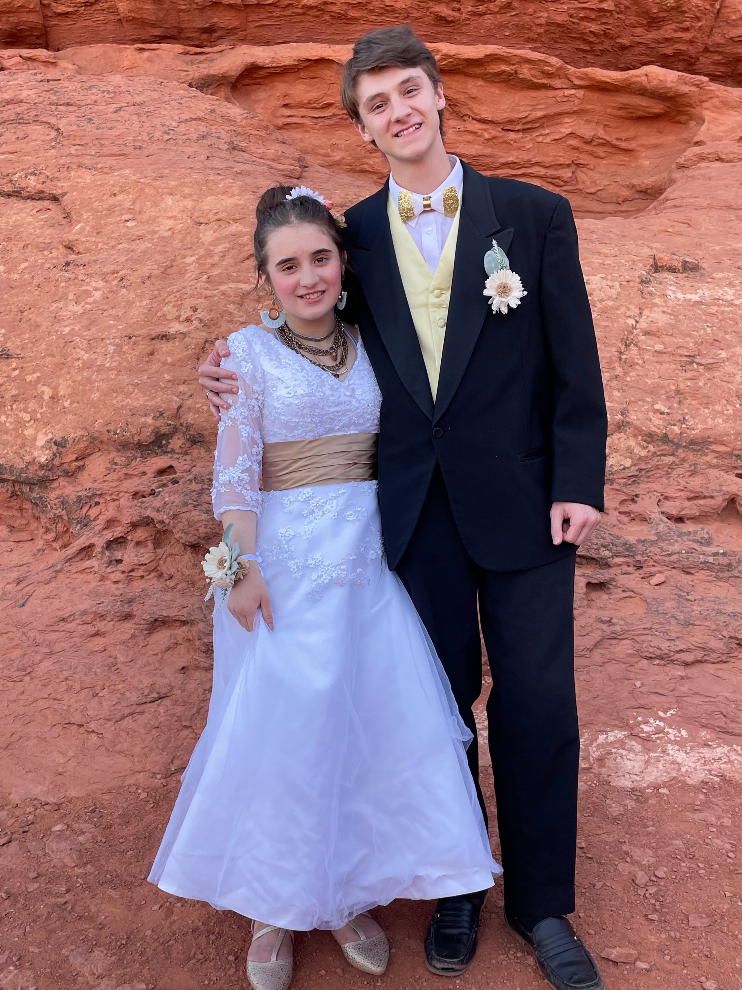 prom couple in white and gold
