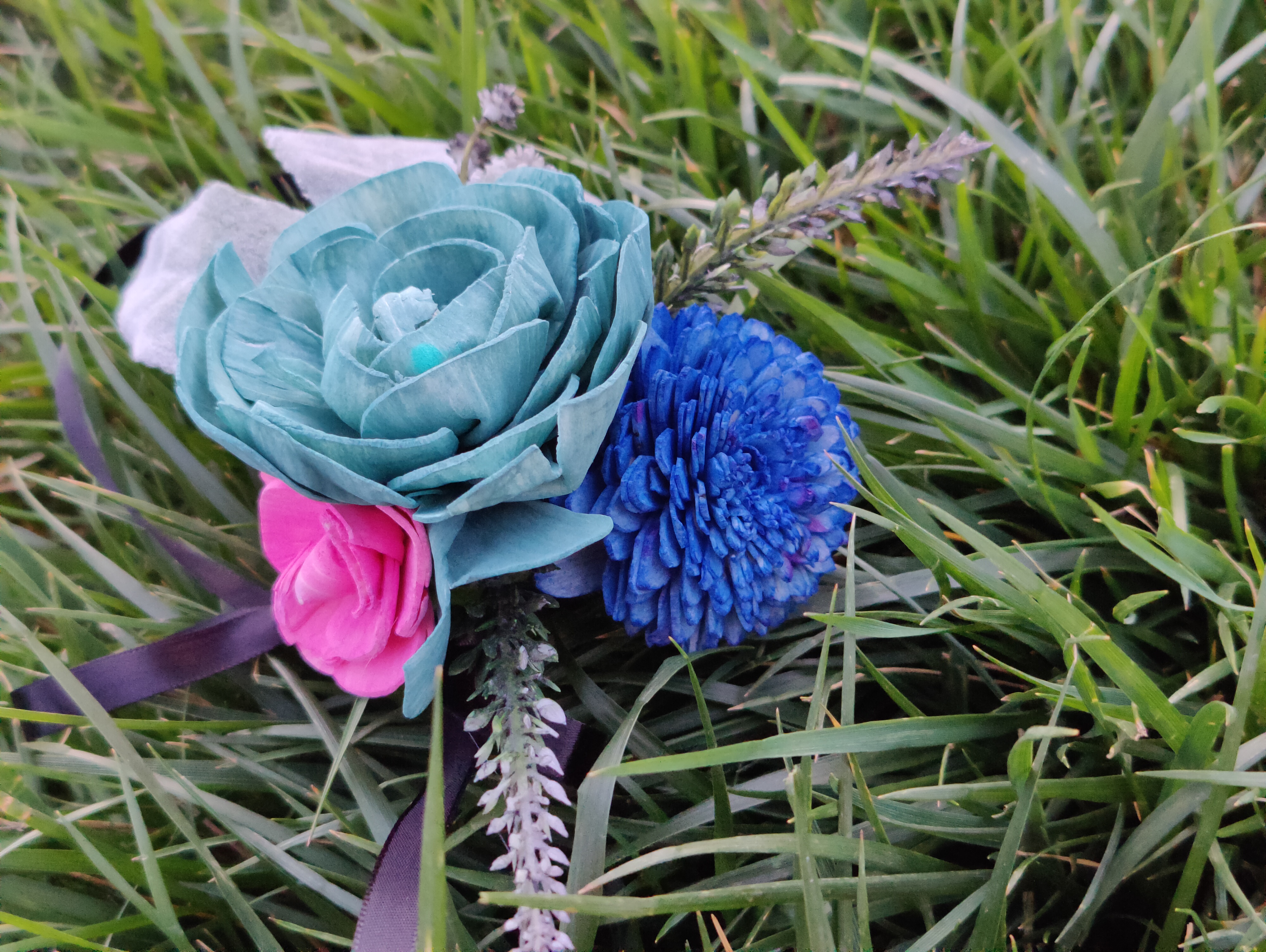 teal, blue, pink, and black corsage