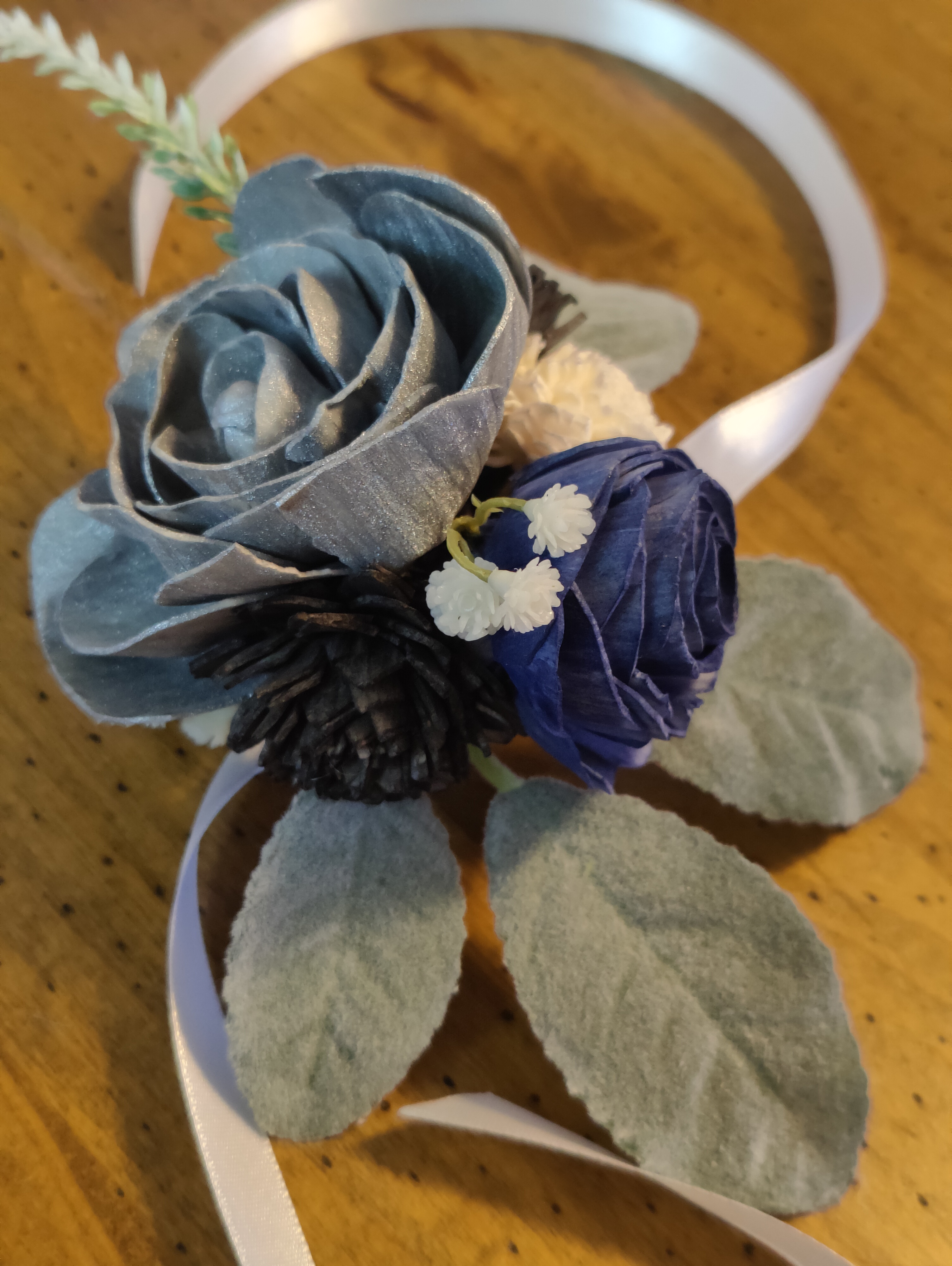 silver, blue, and black corsage