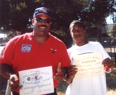 Coach Levy & his son Matthew holding their certificates of participation...