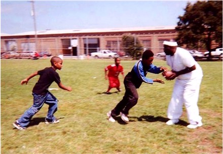 Coach Parker shows the boys how to intercept the ball.&nbsp; 