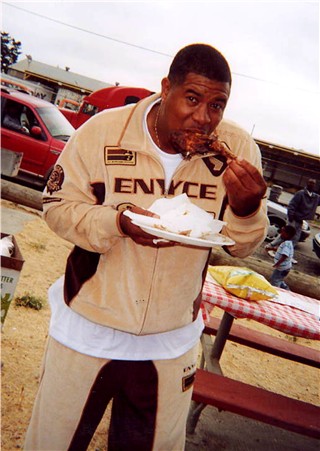 Coach Mike enjoying himself a piece of barbequed chicken!