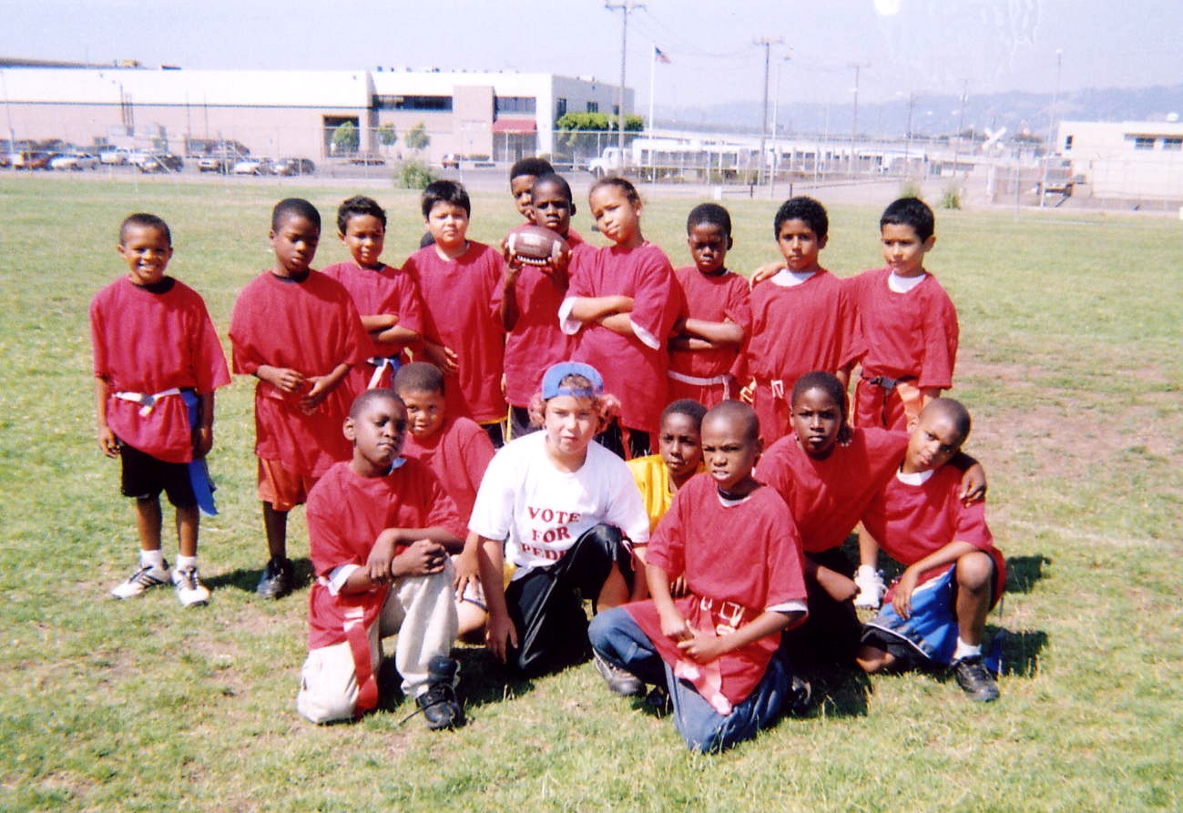 Some of this year's Show-Time Free Football Camp attendees posing in their red shirts which were kindly donated to us.