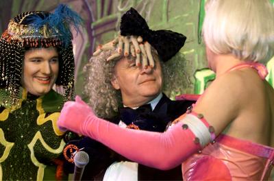 Sir Anthony Hopkins is hugged by male Harvard University students Seth Fenton (L) and Dorian Berger (R) after they dressed him in a hat of fake human fingers and a bra festooned with black lambs' heads while being honored February 15, 2001 as Harvard University's 'Hasty Pudding 2001 Man of the Year.'  Photo by Jim Bourg (Reuters)