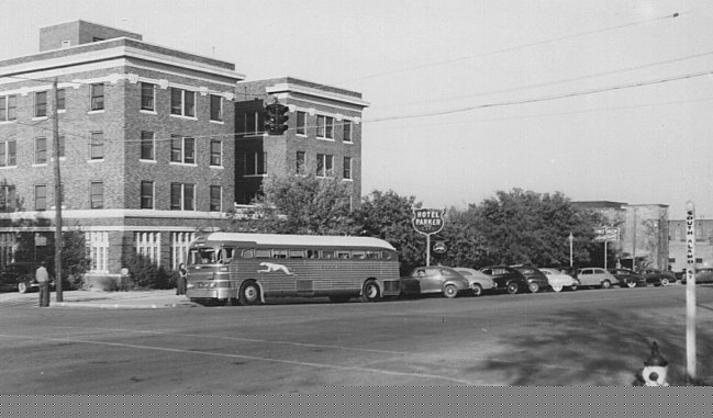 A Greyhound Bus parked at the terminal in the Parker Hotel.