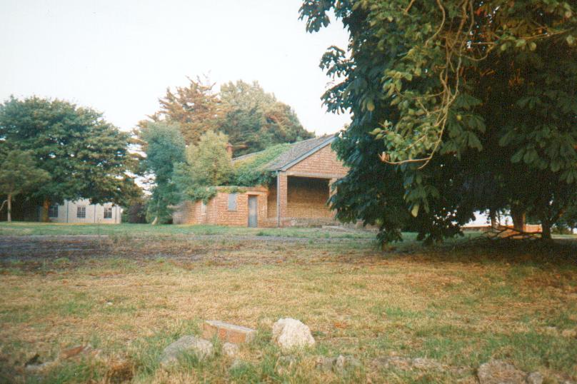 (c.1996) the strong house, probably not a guard house, stands solidly near the maingate. the addition to the left of the builiding is probably of the same date, and has standard MOD blue woodwork paint, although faded) one of the world war two buildings is visible between the trees to the left (note sycamore)