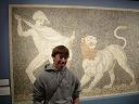 Mackey in front of a mosaic
