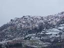 a closer view of the snowy town and mountainside