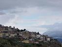 some of the buildings from the nearby town built on the mountainside