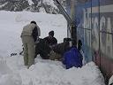 some of the guys attempting to shovel out some of the snow underneath the tires