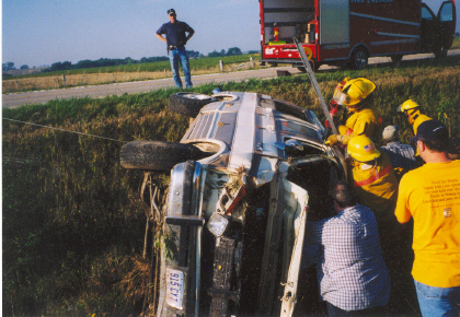 Firefighters work to extricate the driver