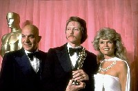 Telly Savalas at the 1979 Oscars alongside Best Supporting Actor Christopher Walken and Dyan Cannon.