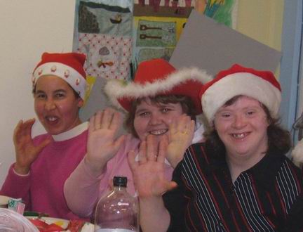 IDEA Members in Christmas hats waving.