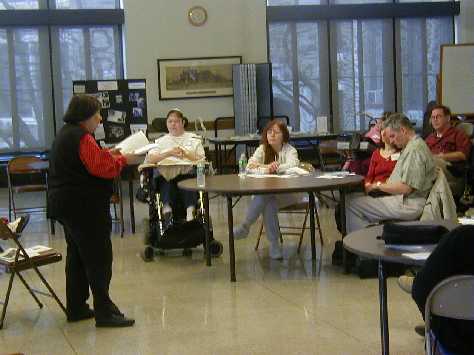 Maria Fama conducts workshop on family history and poetry while poets Lucia Quinn and Daniel Simpson listen.
