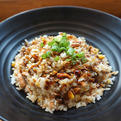 asian rice dish in a black bowl