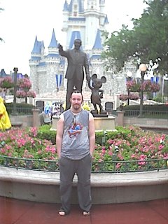 Josh in front of the Walt Disney and Mickey statue