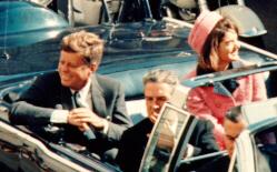 John F. Kennedy cruising around with a personal driver.