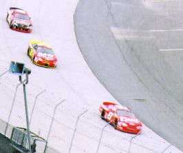 Dale battles Joe Nemechek and Jack Sprague for position.
