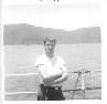 Joe Gross on deck with coast of Viet Nam in background