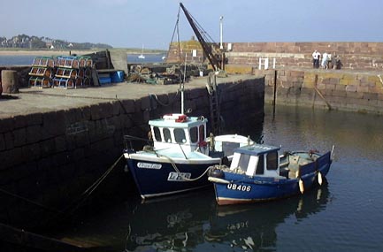 two boats tied up at a pier in the UK