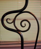 Close up of hand-hammered scroll work on lamp