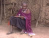 Maasai old woman making jewellery
