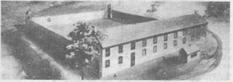 1854 view of prison with wooden stockade around the yard