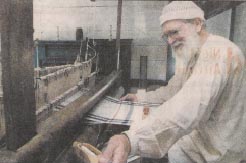 Timber frame loom and the Itinerant Weaver - photo by Star Gazette Sept.8,2002