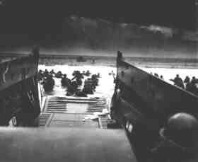 Soldiers reach the beach from a landing ship
