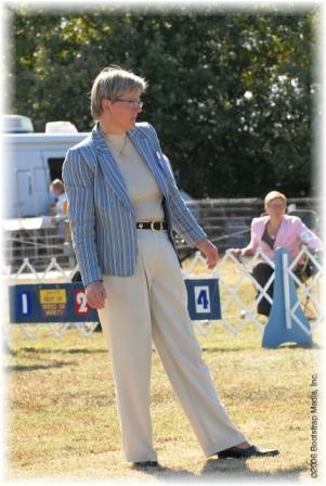 Breeder, Judge: Dr. Tiina Illukka from Finland scrutinizes her entry.