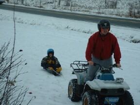 Dad pulling me on my 4 wheeler