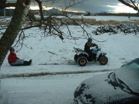 Me pulling dad on my 4 wheeler