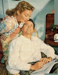 Betty checking out Larry's Script over his shoulder