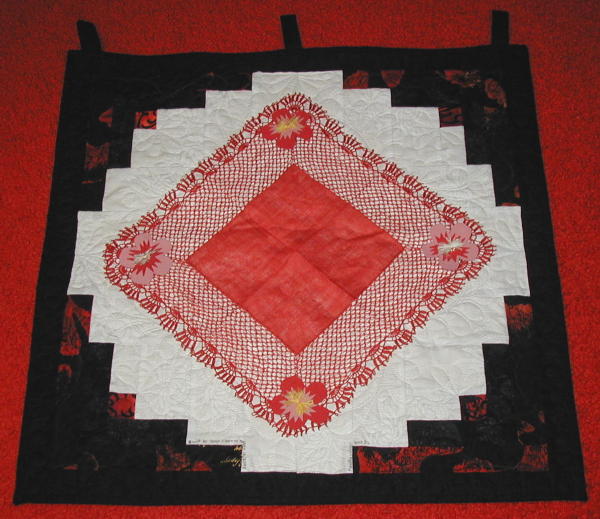 black and white log cabin quilt with red handkerchief