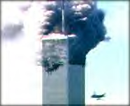 As smoke rises from the floors where a plane struck Tower One of New York City's World Trade Center, foreground, a second plane hurtles toward Tower Two, behind Tower One, moments before its impact. (ABCNEWS.com)