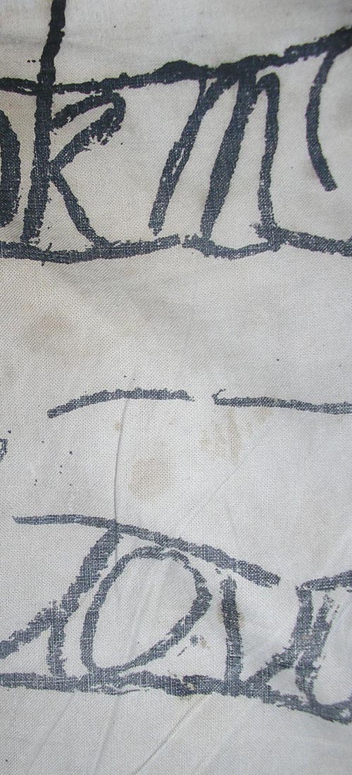 letters written on paper, then distoted, printed onto calico.